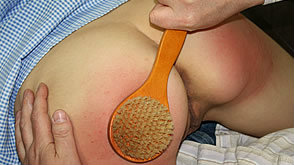 Mishka's bottom is spanked with the bathbrush